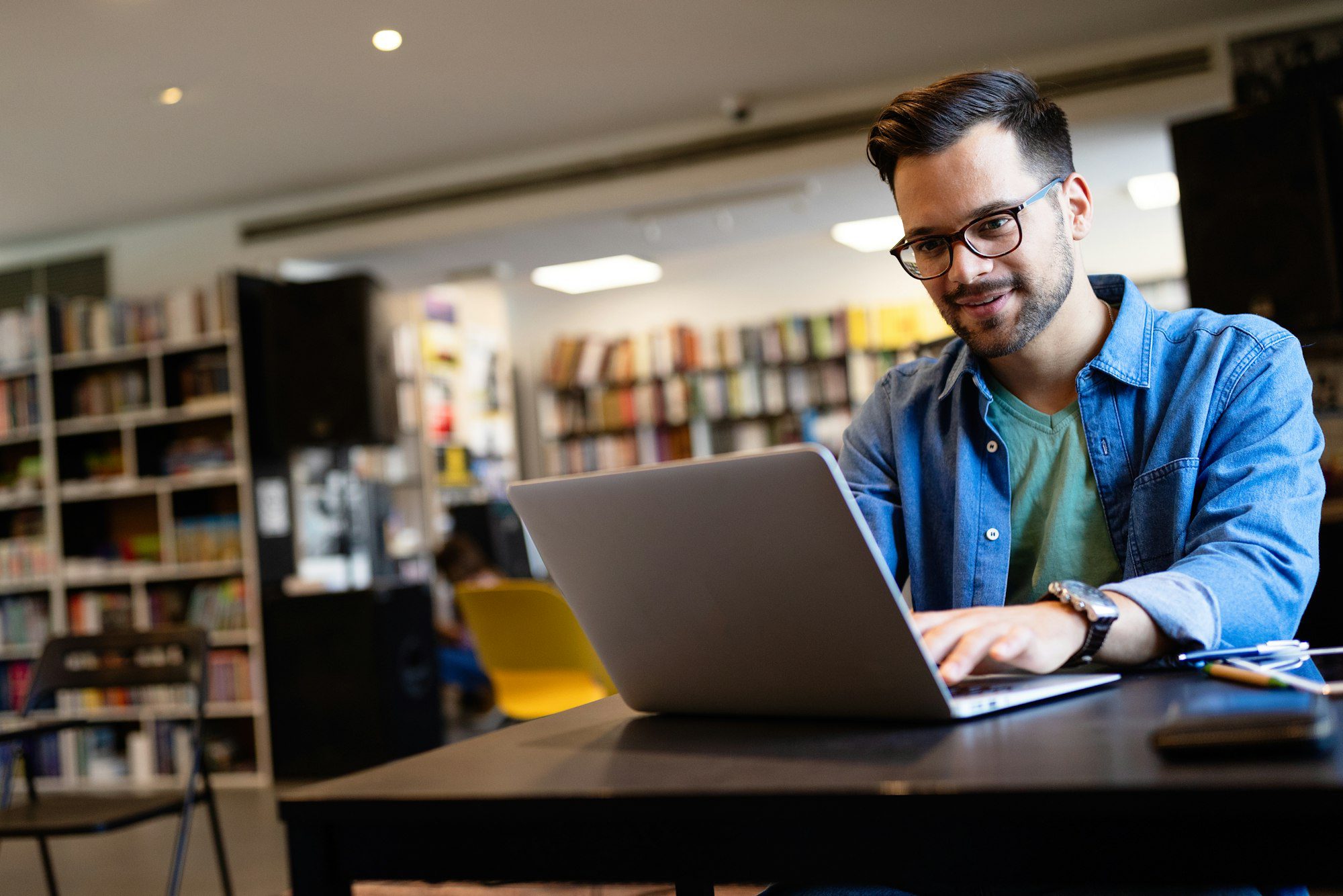 young man at a computer review his website and optimizing content to grow his business