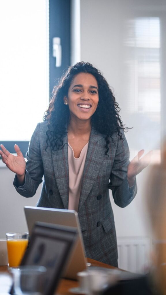 enthusiastic woman presenting her business ideas at a meeting